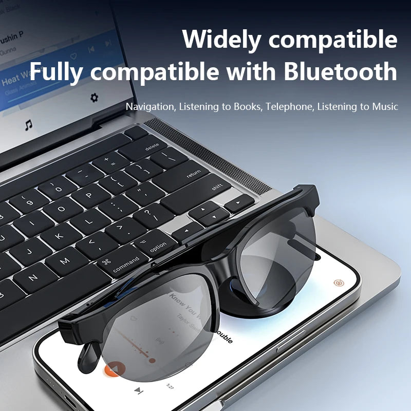 LinguaLens Bluetooth audio sunglasses resting on a laptop and phone